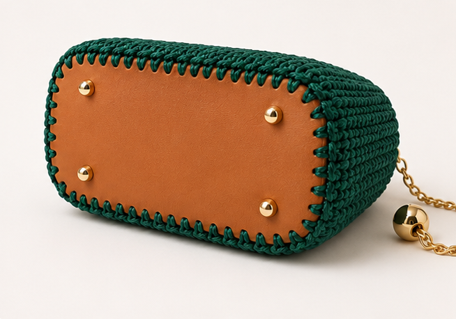 Handmade crochet handbag with top handles, adjustable gold chain strap, turn-lock closure, and gold-tone hardware.