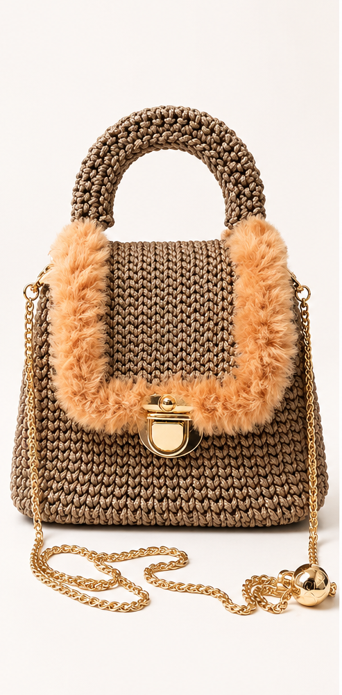 Handmade crochet handbag with top handles, adjustable gold chain strap, turn-lock closure, and gold-tone hardware.