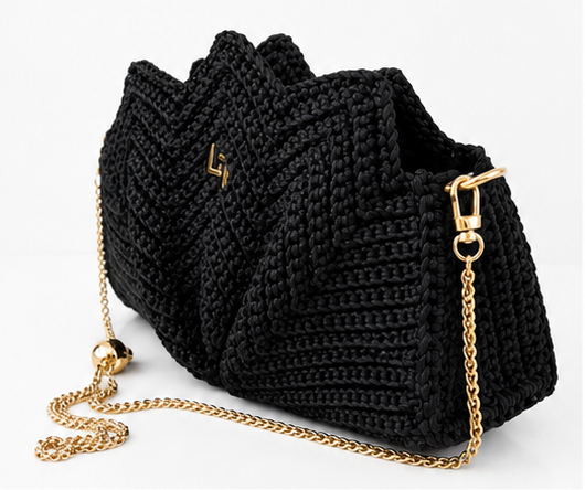Black knitted handbag with gold chain strap on a white background