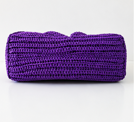 Handmade crochet statement handbag with sculptural pleated design, adjustable gold chain strap, and gold-tone hardware.