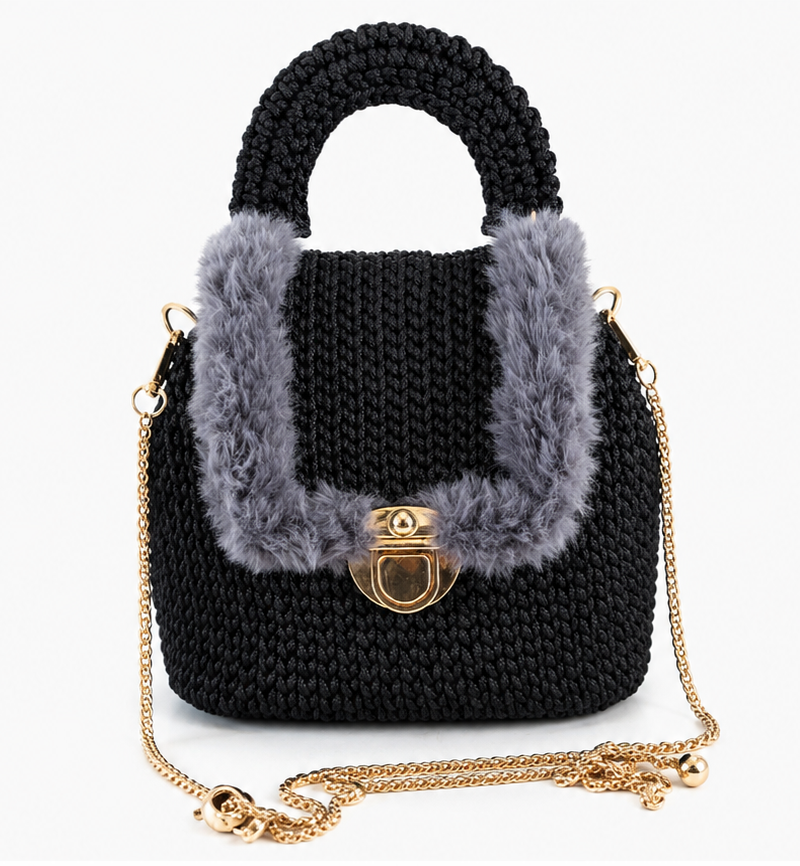 Black knitted handbag with gray fur trim and gold chain on a white background