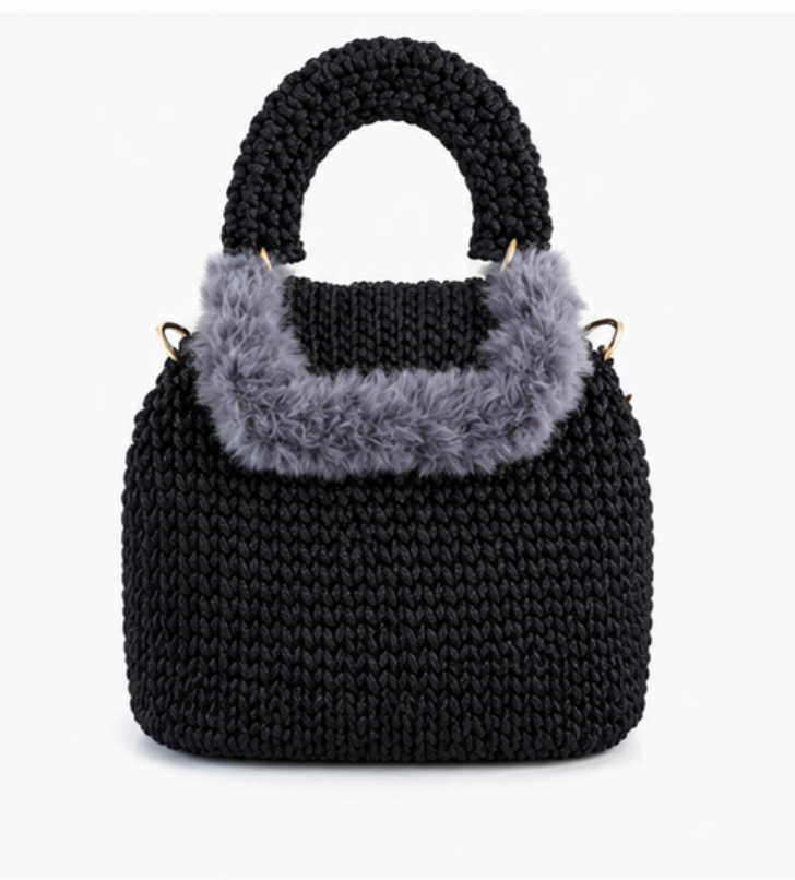 Black knitted handbag with gray fur trim on a white background