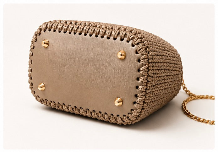 Handmade crochet handbag with top handles, adjustable gold chain strap, turn-lock closure, and gold-tone hardware.