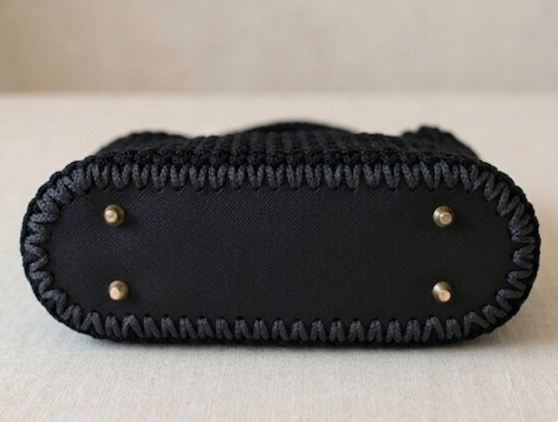 Handmade crochet handbag with structured silhouette, convertible chain handle, and gold-tone hardware.