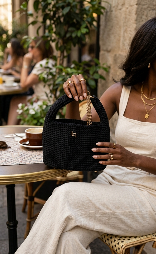 Handmade crochet handbag with structured silhouette, convertible chain handle, and gold-tone hardware.