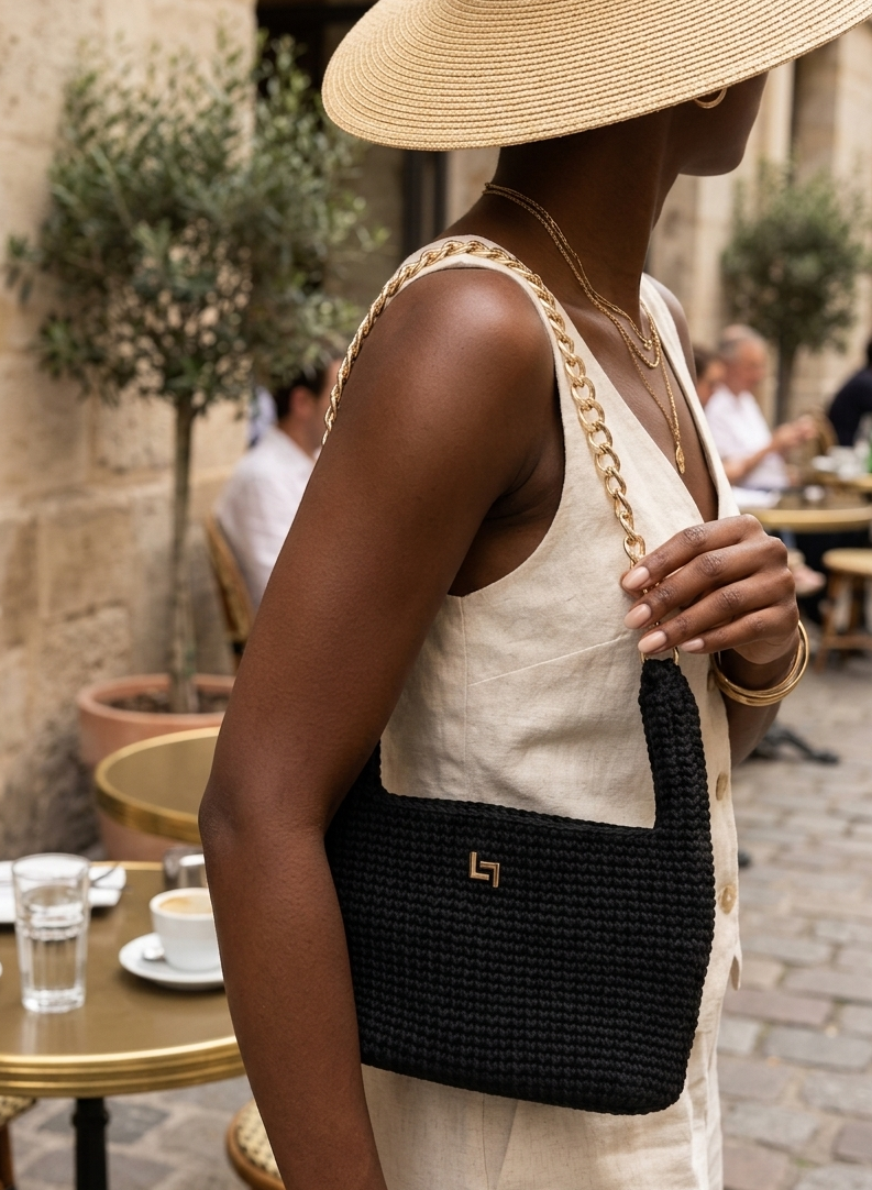 Handmade crochet handbag with structured silhouette, convertible chain handle, and gold-tone hardware.